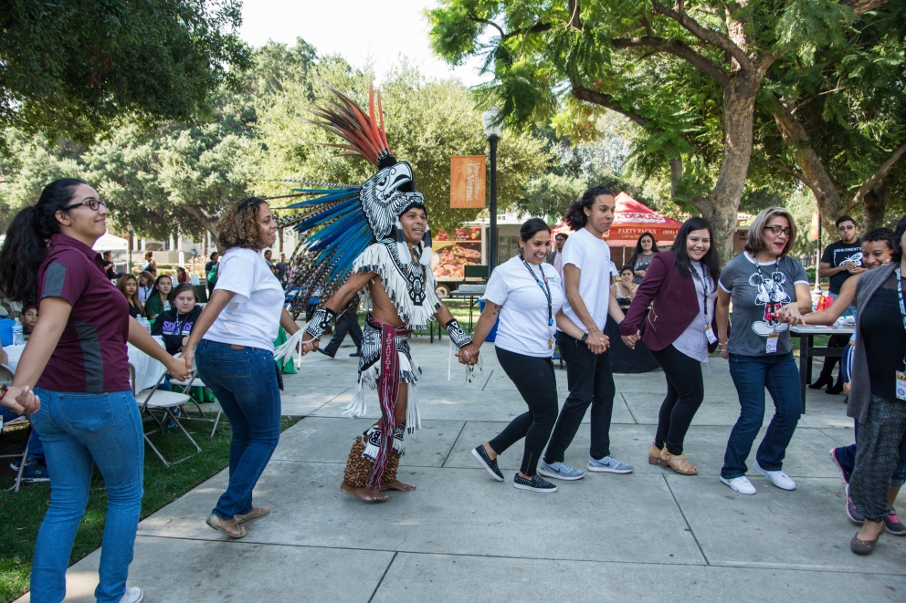 Students and families enjoy a performance by Aztec dancers at the Latino Education Access and Development Conference