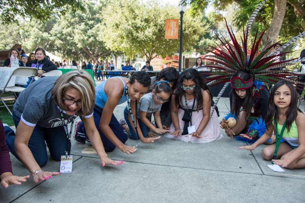 Students and families enjoy a performance by Aztec dancers at the Latino Education Access and Development Conference