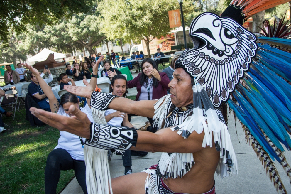 Students and families enjoy a performance by Aztec dancers at the Latino Education Access and Development Conference