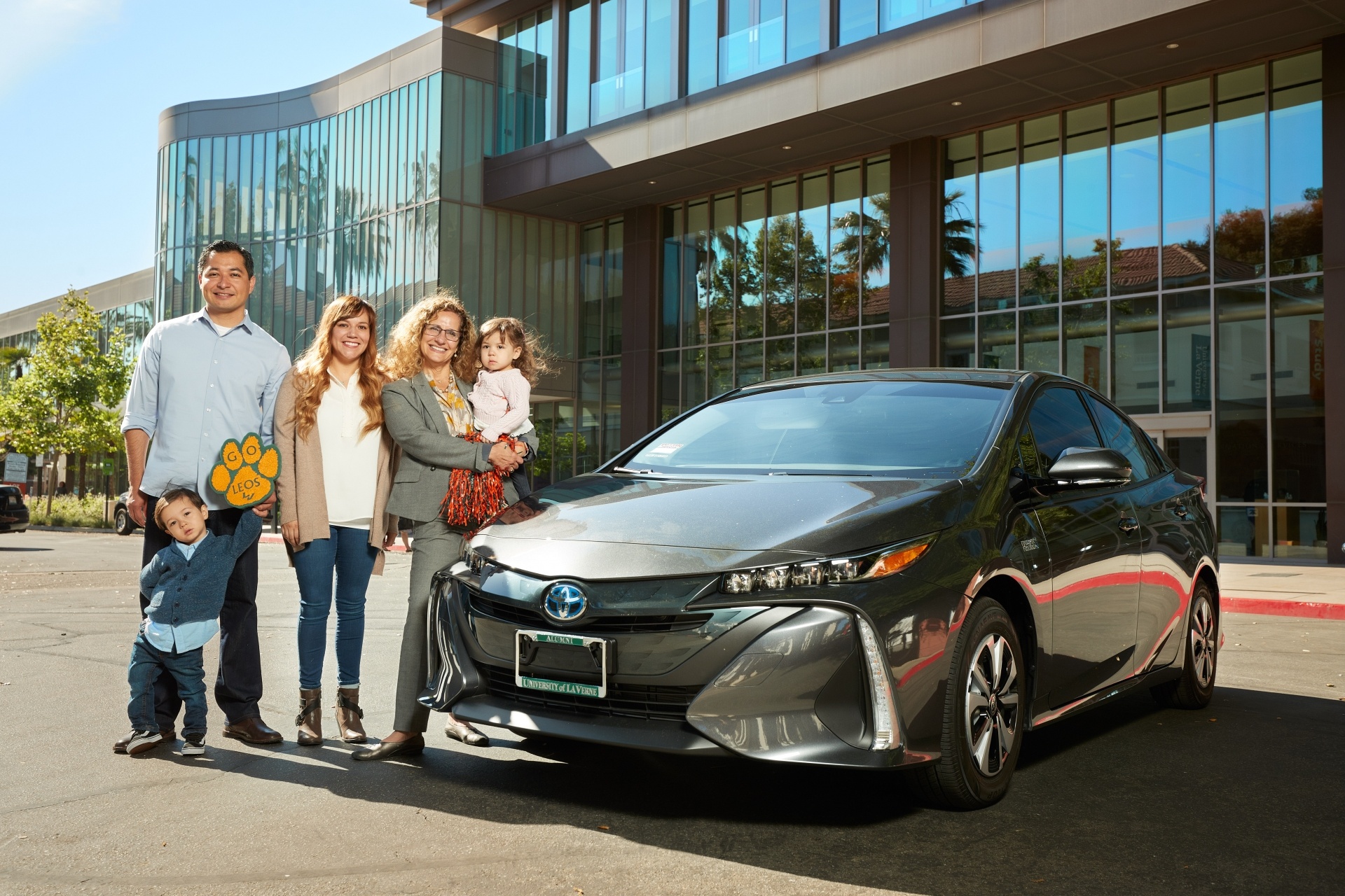 Scholarship fundraiser raffle winner poses with new Toyota Prius
