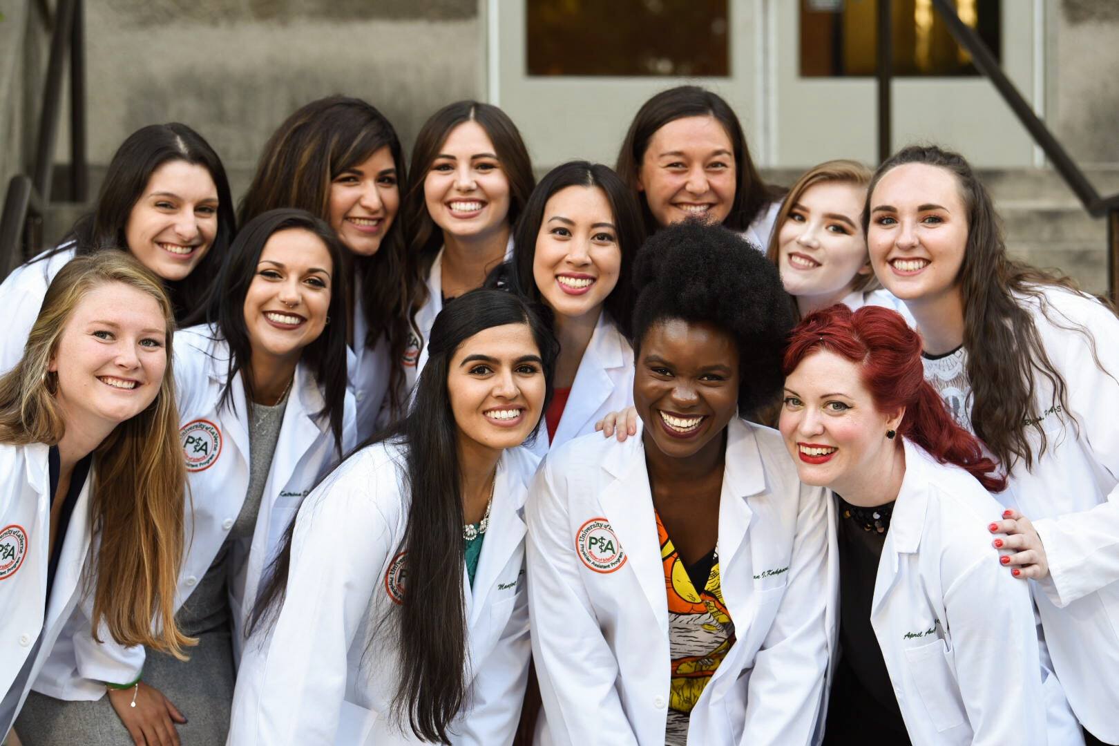 Students smile at the Physician's Assistant Program white coat ceremony.