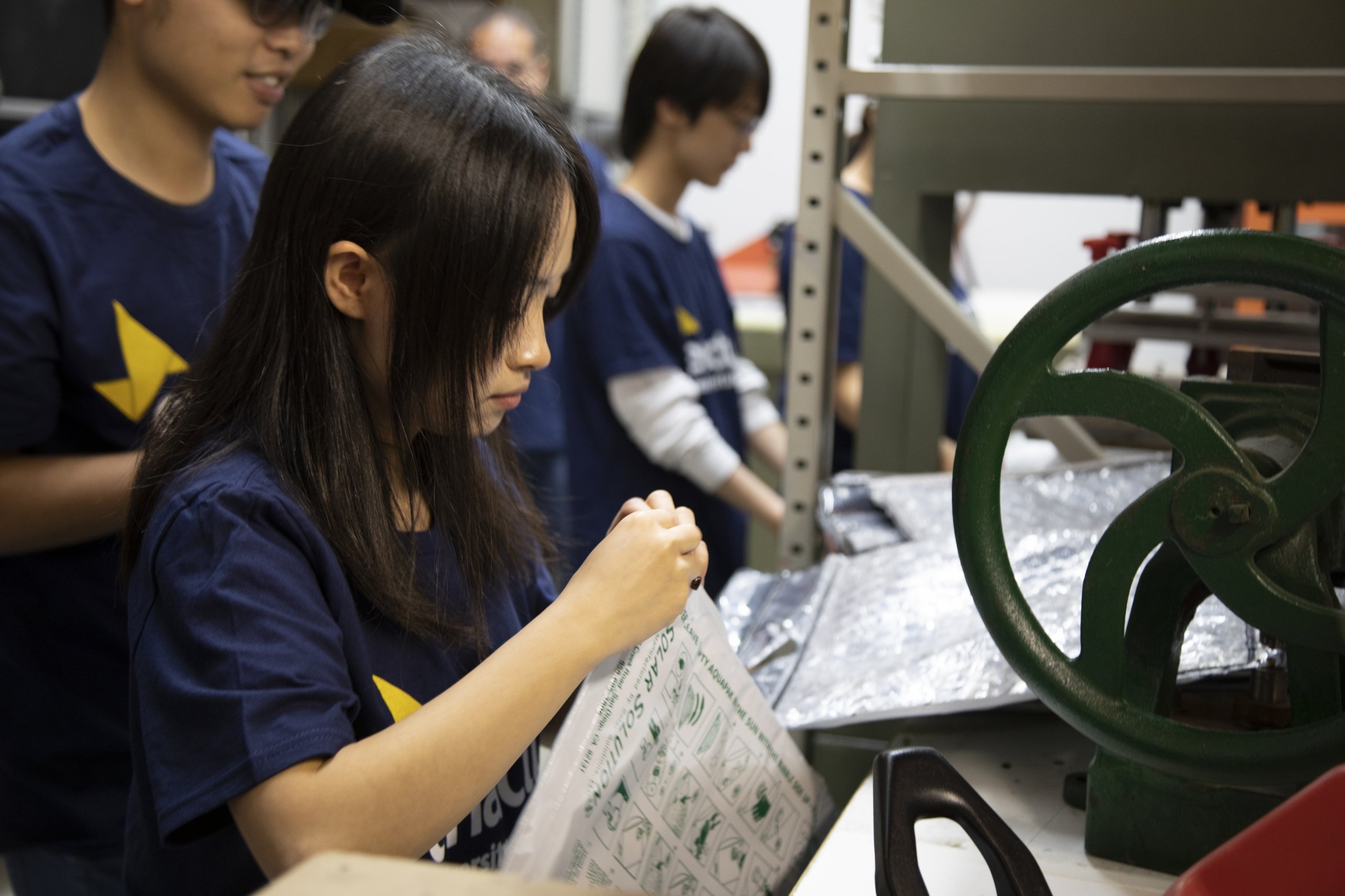 Female student assembles solar water pack