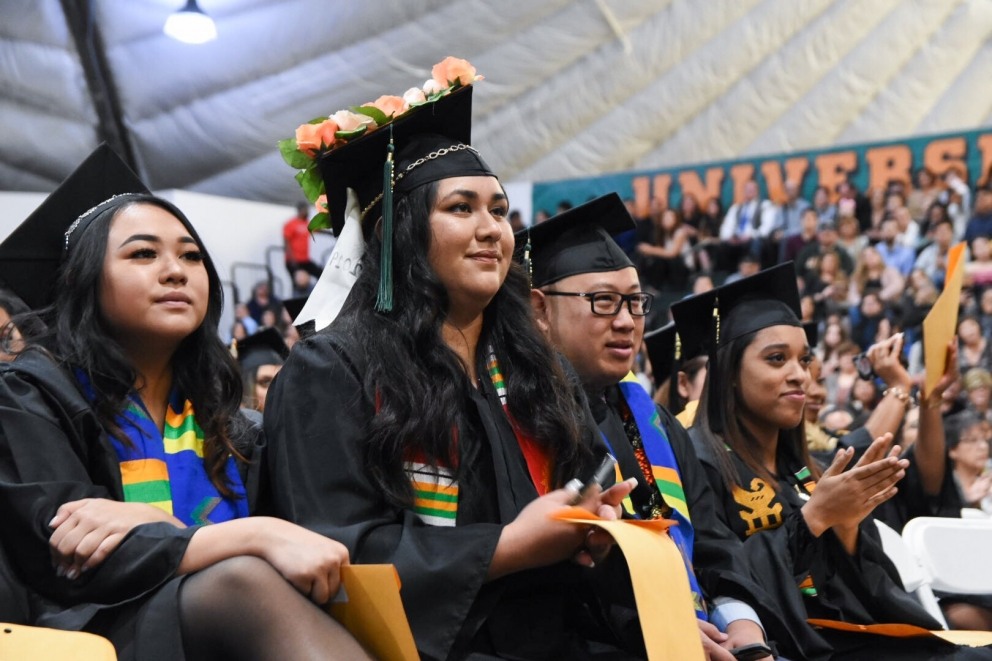 Students sit during cultural celebration