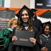 Female student holding diploma