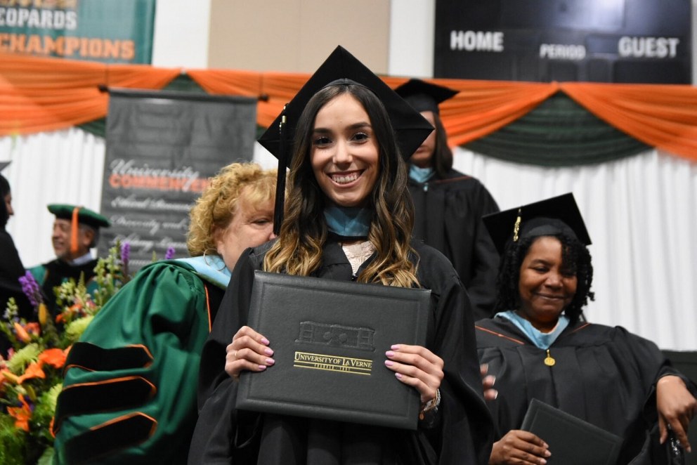 Female student holding diploma