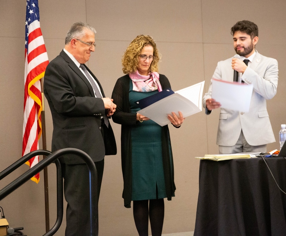 Dean Abe Helou and University President Devorah Lieberman accept certificates