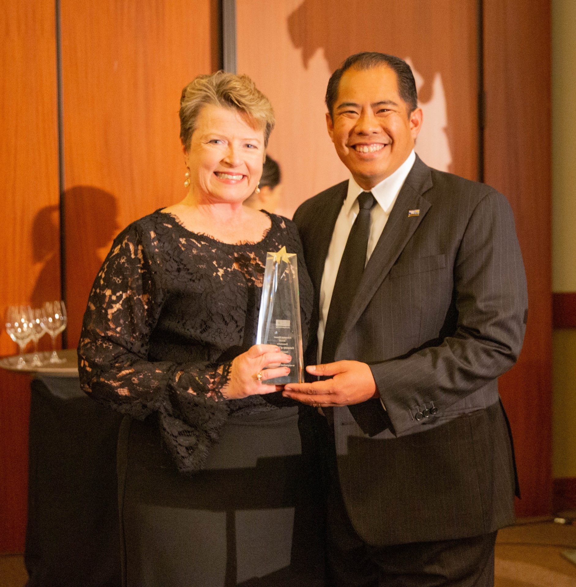 Sherri Mylott holding the Education Pioneer Award