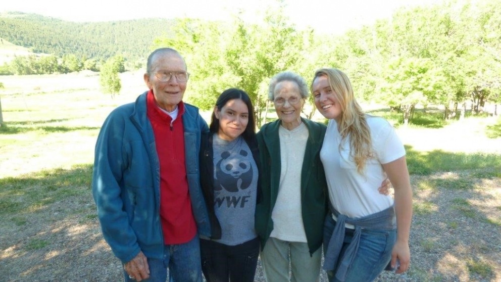 Bob and Mary Neher pose for a photo with students