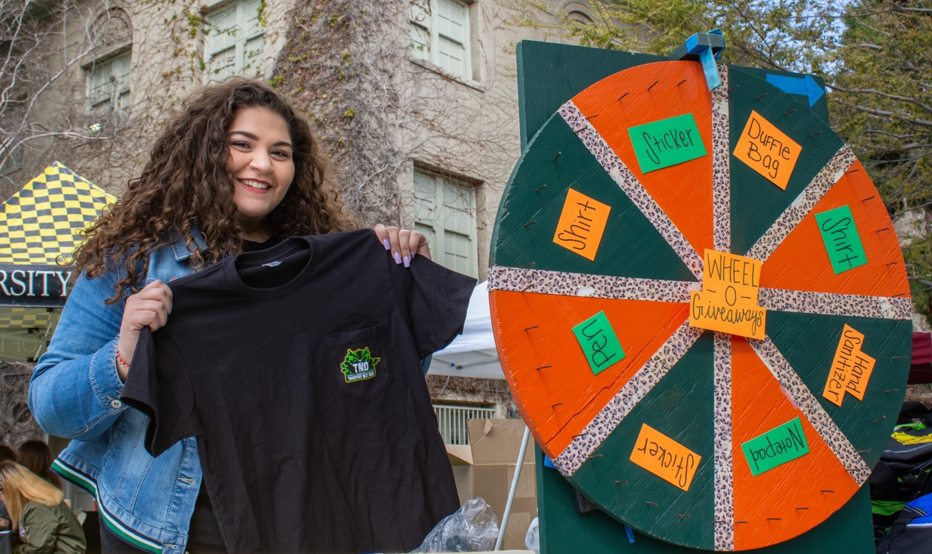 Transfer student holding a University of La Verne t-shirt