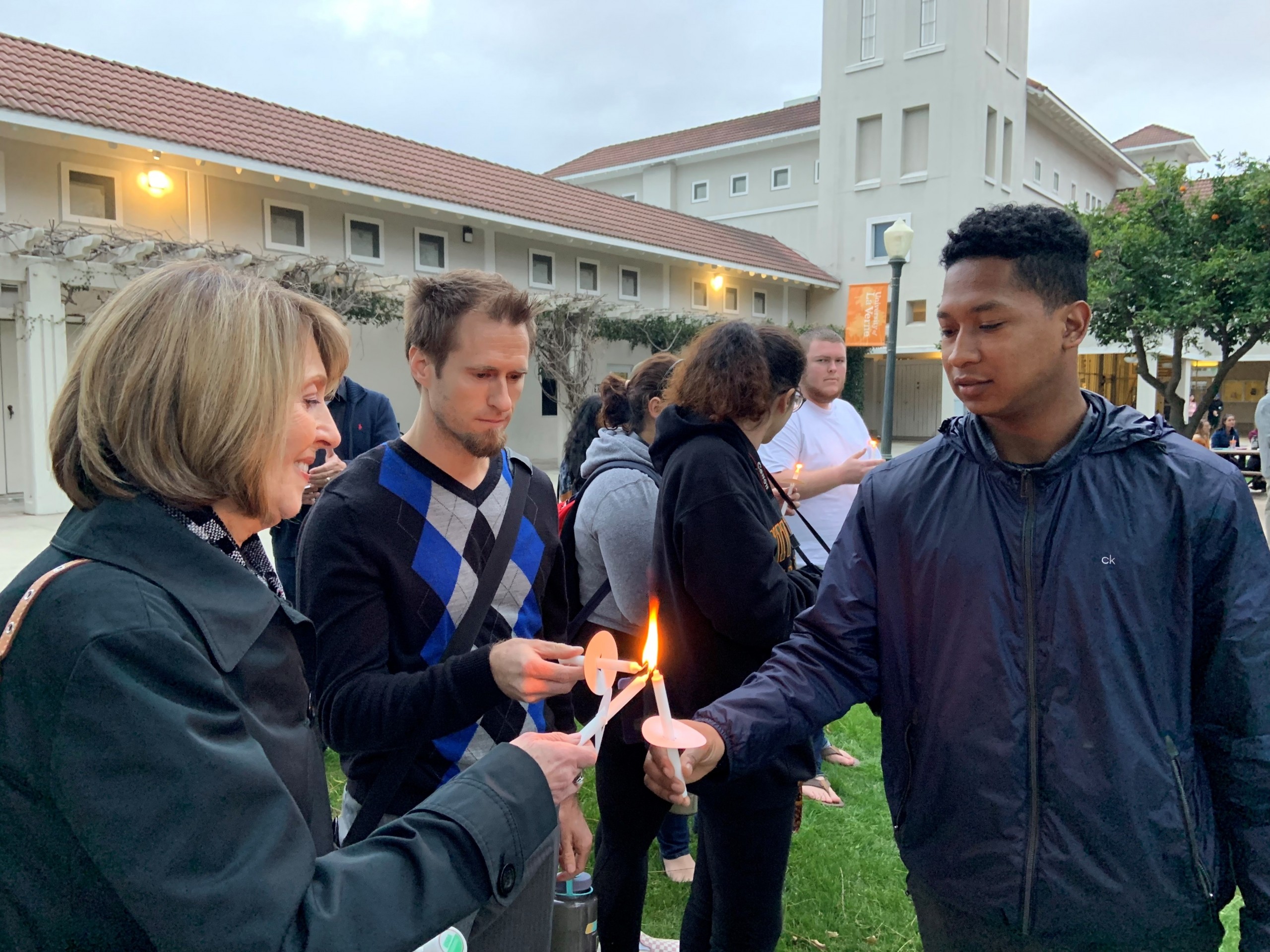 Students gather to light candles during vigil