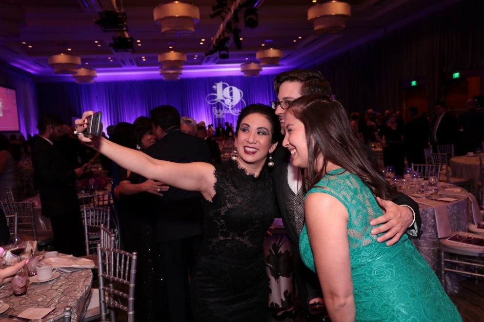 Board of Trustee Wendy Lau snaps a selfie with friends at the Scholarship Gala.
