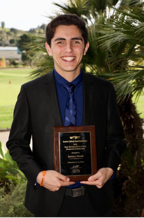 Zachary holding his award