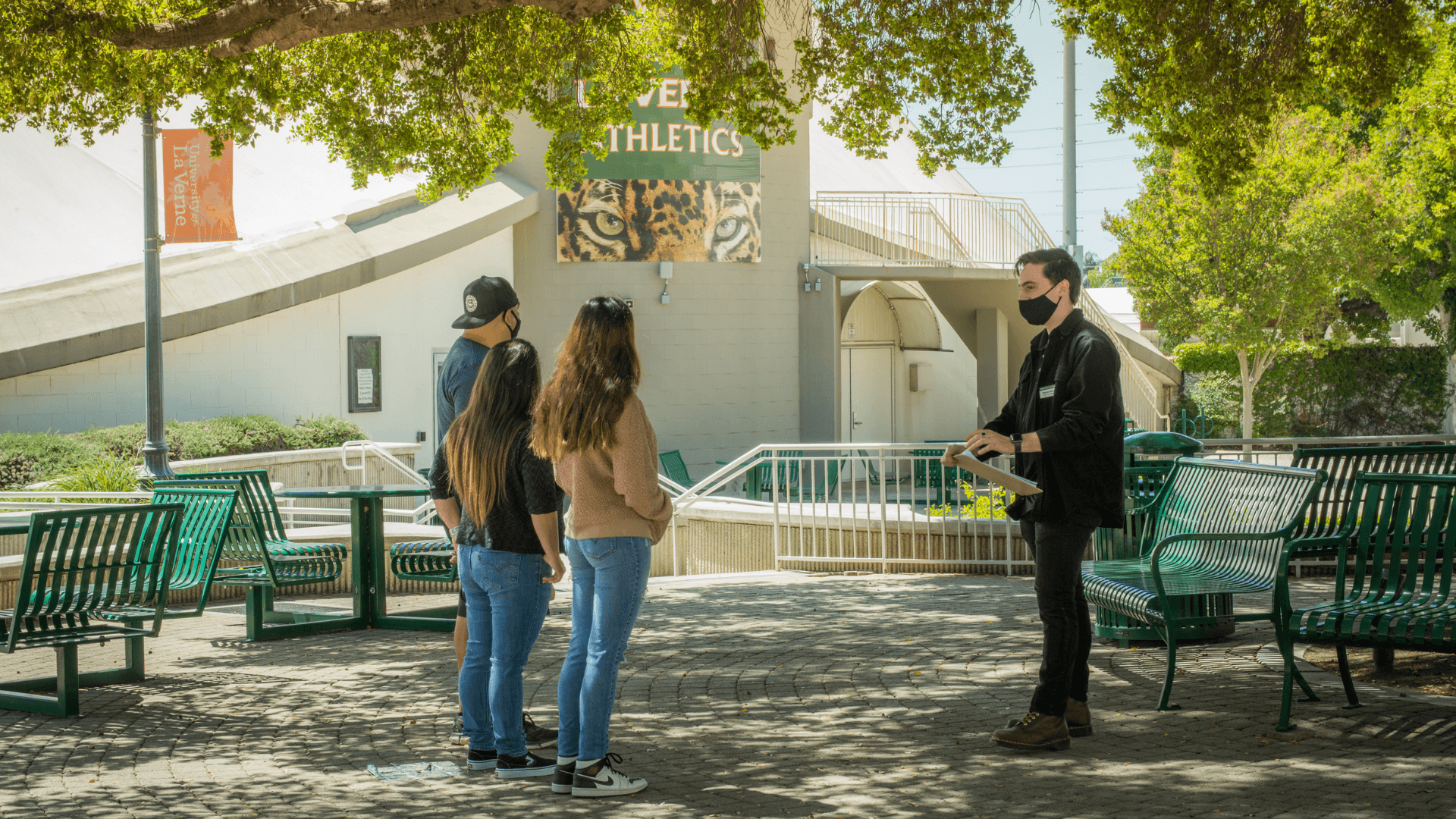 Tour guide leads in-person campus tour