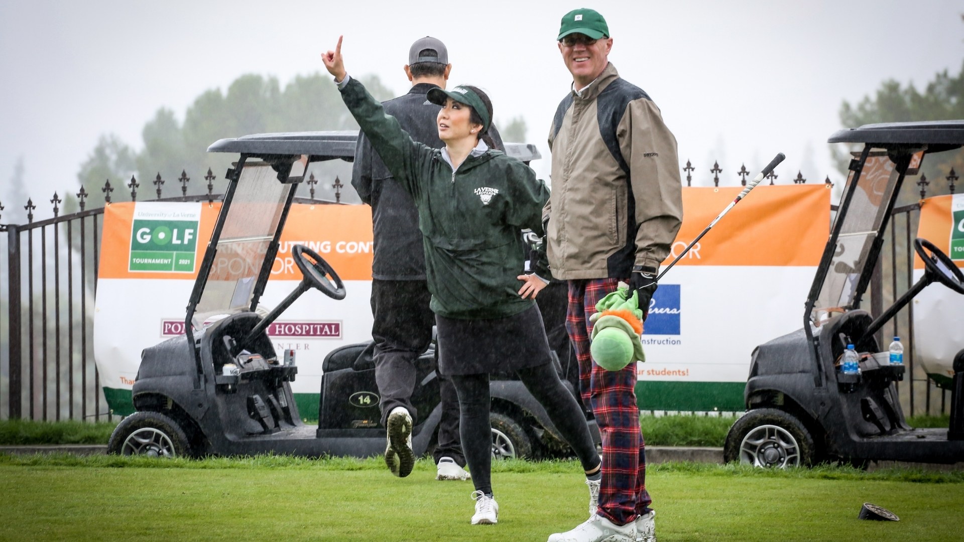 Golfers in the rain on golf course