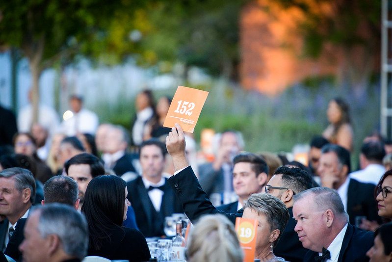 Guests participate on the paddle raise at the University of La Verne's 2022 Scholarship Gala.