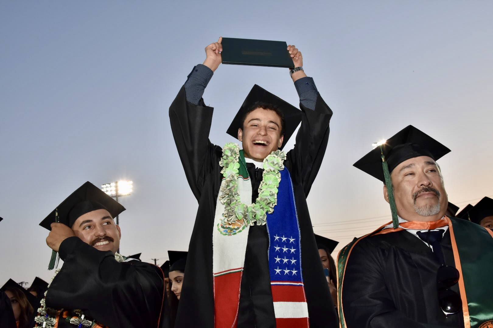 Graduate holding diploma